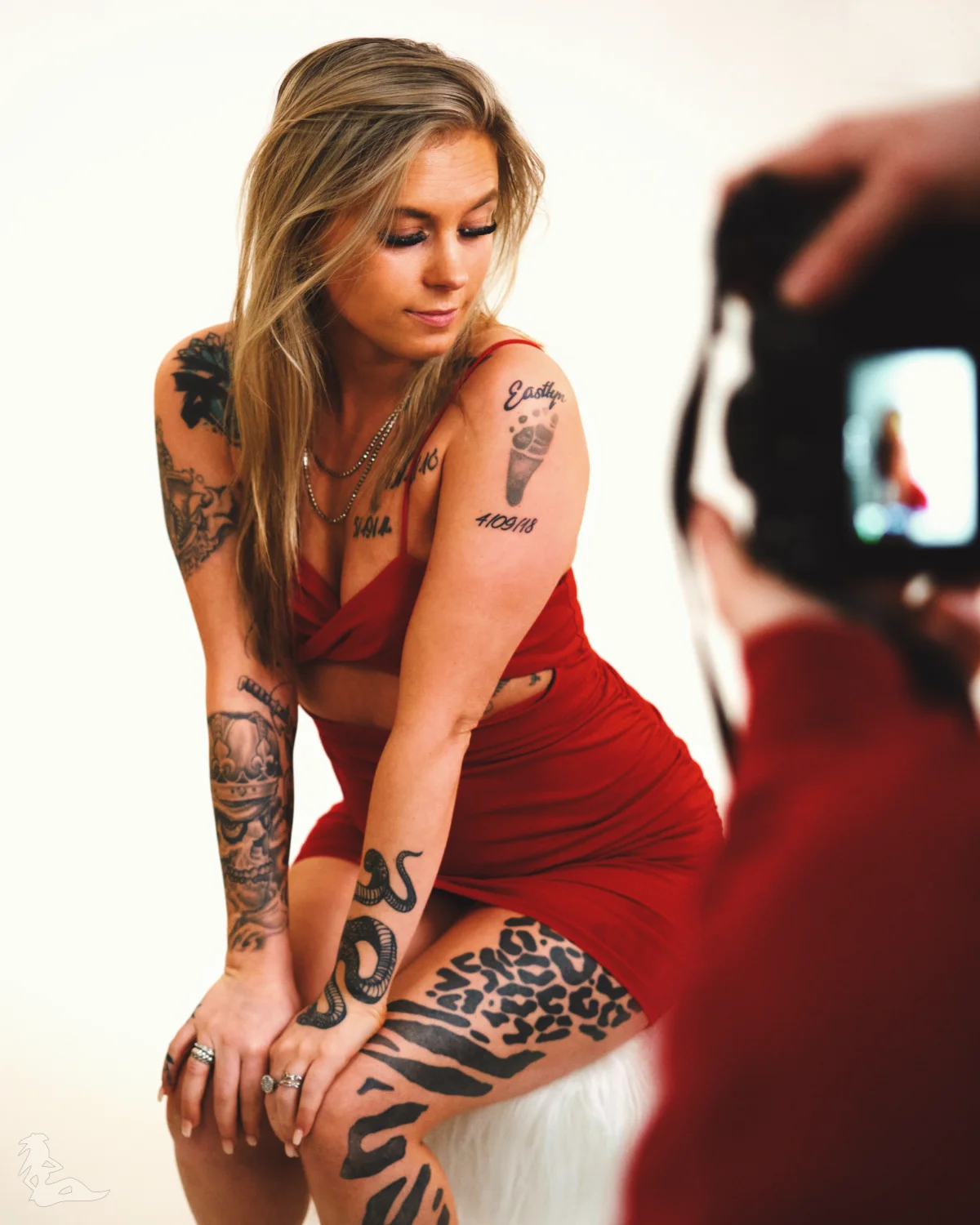 Amber in red dress posing in the studio